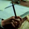celli: a woman's hand holding a fountain pen, with paper in the background (Regency writing)