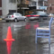 metawidget: A traffic cone and a blue chair sitting in the parking lane of a city street. (art or moving)