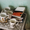 chalcopyrite: a tray or tabletop covered with teacups and a pile of books (books: and tea)