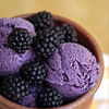 chalcopyrite: a bowl of blackberry icecream, topped with ripe blackberries. Luscious purple. (food: blackberries and ice cream)