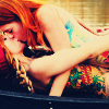 argylepiratewd: Two naked women (one with red hair) with colorful tattoos making out in a rowboat (Colorful Tattooed Girls in Boat)