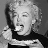 innocentsmith: marilyn monroe eating a piece of cake, with gusto (marilyn: cake is nom)