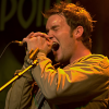 fatoudust: Gareth David Lloyd wails into the mic, lit in yellow (gareth)