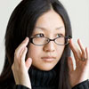 advisor: A woman steadying her glasses with her hands. (Default)