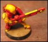 metahacker: A small figurine with a big gun, painted bright yellow and red (tau)