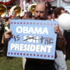 kshandra: Toby Ziegler, marker in hand, holding a sign that has been doctored to read "Obama f/o/r IS THE President" (West Wing Obama)
