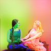 mercredigirl: Screencap from Wicked in green and pink tones: Galinda (Kristin Chenoweth) holding Elphaba's (Idina Menzel) hands. (Wicked friendship)