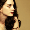subluxate: A picture of Anne Hathaway against a dark beige background, looking to the side (Actor: Anne Hathaway)