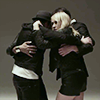 venusinthenight: a still from metric's 'youth without youth' vide where they're huddled together, emily looking at the camera (metric - group hug (ywoy))