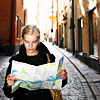 fish_echo: photo of a girl looking at a map while standing on a side street (Misc-girl with map on a street)