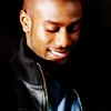 actionreaction: photo of michael obiora, looking down and smiling ([characters] dean)