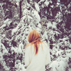 ofearthandstars: Woman clad in white, facing away, into snow-covered trees. (winter trees)