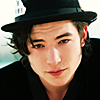 actionreaction: photo of ezra miller wearing a black hat, smiling slightly ([characters] corvus)