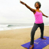 semielliptical: Black woman practicing yoga on a beach (yoga by the shore)