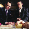 esteefee: Finch changing baby Leila's diaper while John looks on with a disturbed expression. (leila_poi)