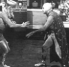el_enmascarado_de_plata: Santo in a silver full face Spandex mask and sequined cape, fighting a Martian in a gold lame' hat and ridiculous wig (it's rasslin' time in the lab (b&w))