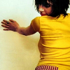 tree: pj harvey wearing yellow, her hands against a wall and her head slightly turned away ([else] to rid us)