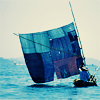 cadenzamuse: A patchwork blue sailboat on a bright blue ocean (the sea was patchwork blue)