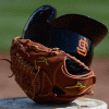 telesilla: an sf giants batting helmet inside a baseball glove (sf giants glove)