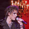 princesse_incongrue: Mikelangelo Loconte singing into a microphone in front of a red background (mikele rocking)