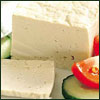 raletha: block of raw tofu with sliced tomato and cucumber garnish (food & drink - raw tofu)