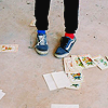 gradient: a photo of someone's sneakers with cards scattered around them (scatter)