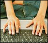 indy_go: Hands typing on a laptop. (Default)