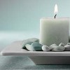 theraveledskein: lit candle sitting on dish with rocks (serenity)