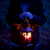 alwayswondered: Someone holding a lit lantern in the dark. (I will leave the front light on.)
