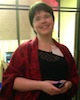 aedifica: Me looking happy, wearing a black dress and a red shawl (WisCon 2013)