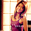 winkingstar: Kona (Hawaii Five-O) smiling in golden light with text "Smile!". ([H50] Kono smile)