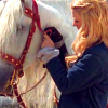 briar_pipe: Morgause fixing her horse's cheekstrap (Morgause & horsie)