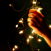 existence: stock icon of hand with christmas lights (fiat lux)