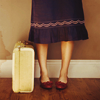 ex_we935: Cropped photo of a woman standing next to a suitcase. (Kerry - Travel)