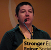 rmc28: Rachel speaking at a lectern with microphone and part of the slogan "Stronger Economy Fairer Society" in shot (libdem)