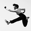 daughtercell: Musician Janelle Monae jumping in the air and frozen in a pose with one fist forward, looking as though she is running. (Janelle powering forward)