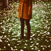 rainfall: A girl stands in the midst of fallen leaves. You can't see her face. (Default)