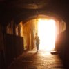 highlyeccentric: An underground street (Rue Obscure, Villefranche), mostly dark. Bright light at the entrance and my silhouette departing (Rue Obscure)