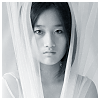 meloukhia: A woman's face surrounded by gauzy curtains (Woman in sheers)