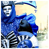 meloukhia: A person dressed in blue and wrapped in elaborate layers of blue fabric (Blue person)