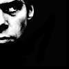 elaineofshalott: Black and white photo of part of Nick Cave's face; he looks sinister. (black!)