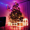 alwayswondered: A Christmas tree and presents outlined in fairy lights in a warm living room. (Christmas: pretty pretty lights)