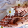 recessional: hennaed hands holding a flower (personal; hands of light)