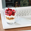 milkymoon: A yoghurt parfait resting at the edge of a white laptop. (Computing & yoghurt.)