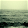 wake: Choppy grey-green ocean. (At sea)
