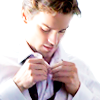 badparsiqueer: person with dark hair buttoning up a white men's dress shirt carefully (Default)