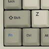 celli: closeup on keyboard keys alt, control, and "smite," and then a lightning bolt in front of a monitor (smite)