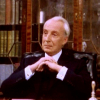 mightthinkthat: Francis is looking interested, sitting behind his desk. (considering)