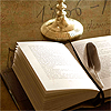 booksofafeather: A book and candlestick, with a feather lying across the pages. (Default)