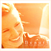 tinny: Veronicy Mars smiling in orange "Beauty" (veronica_mars_beauty by oxoniensis)